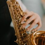 Close-up of a child playing a saxophone, highlighting musical details.